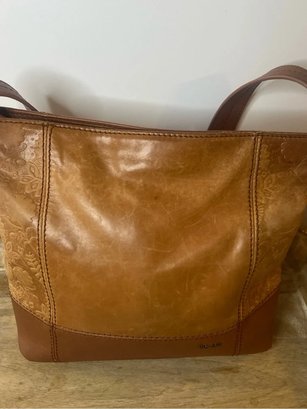 The Sak tan leather crossbody with beige interior